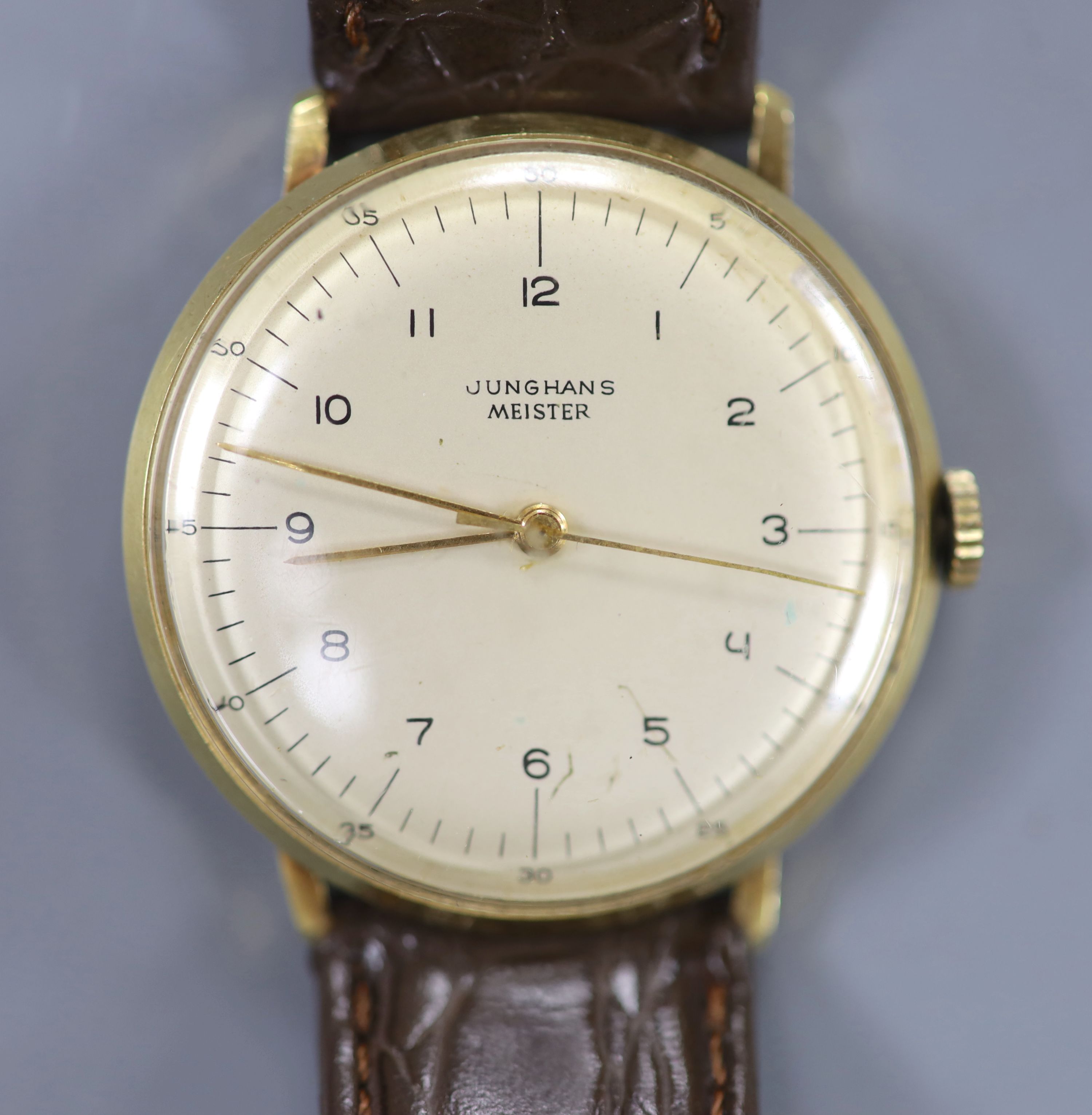 A gentlemans 14ct Junghans Meister manual wind wrist watch, on a associated leather strap and case back inscription,